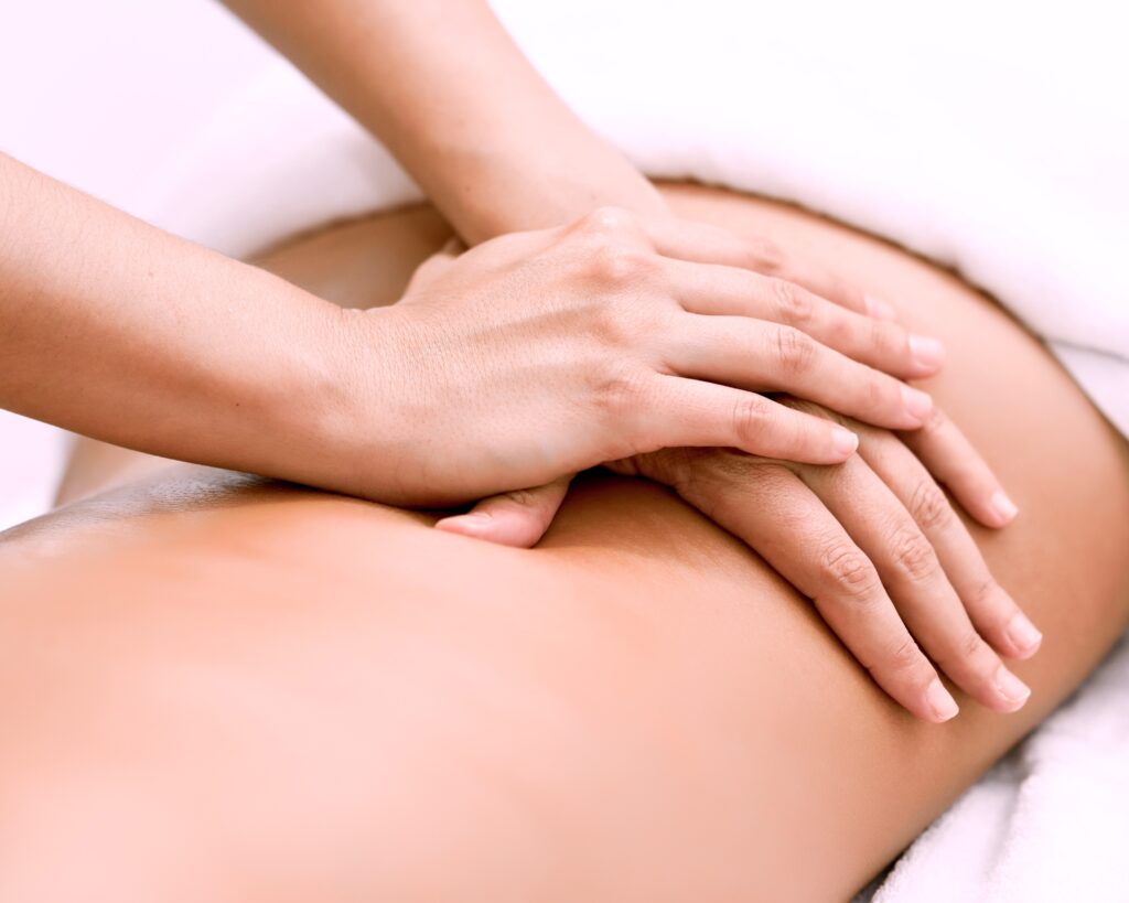 Young woman receiving a back massage in a spa center.